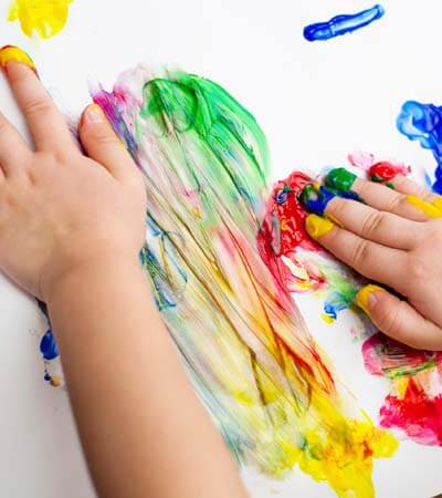 child finger painting