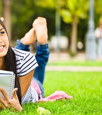 teen girls read on grass